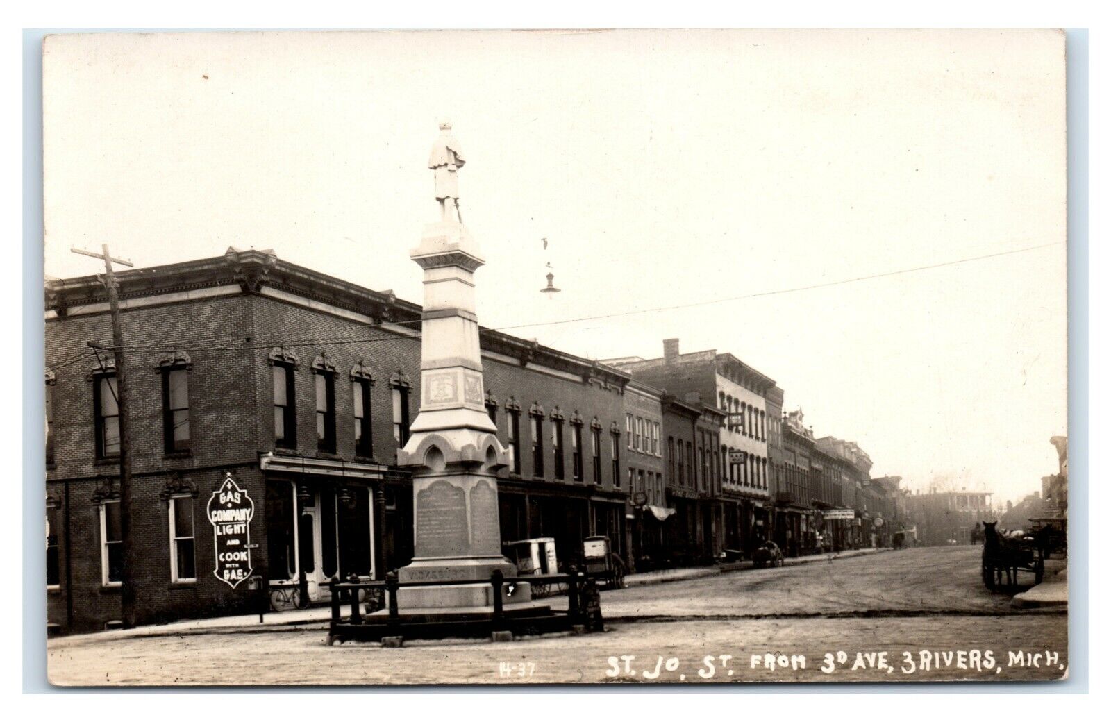Postcard St Jo St from 3rd Ave, Three Rivers, Michigan Monument gas co RPPC L49