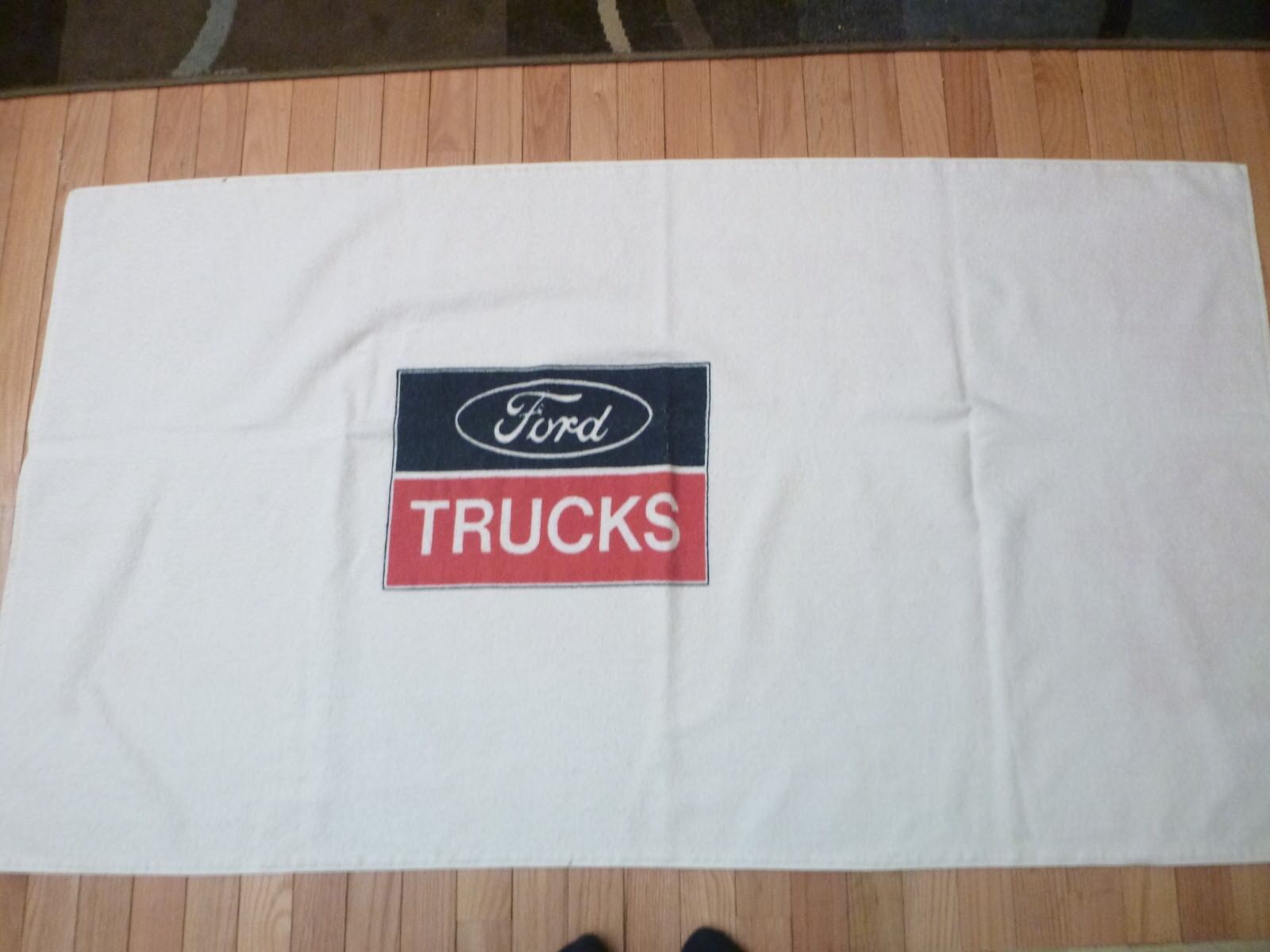 FORD WHITE BEACH TOWEL WITH RED, WHITE & BLUE FORD  HEAVY TRUCK EMBLEM IN CENTER