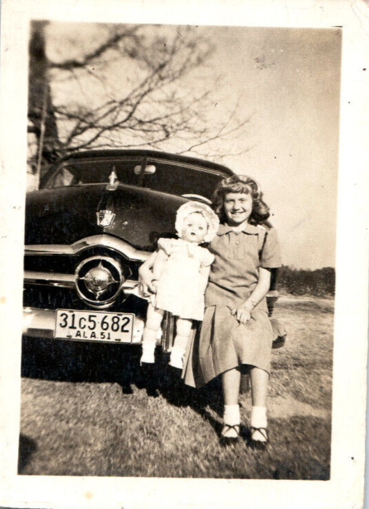 Vintage Photo 1940s, Girl w/ Baby Doll Posed on Car Bumper 3.5x2.5 Black White