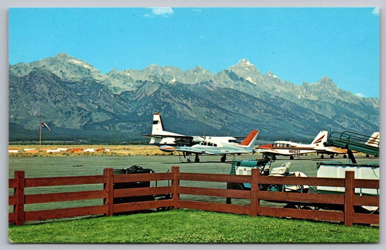 Wyoming Jackson Hole Airport Grand Tetons Airplane Mountains Vintage Postcard