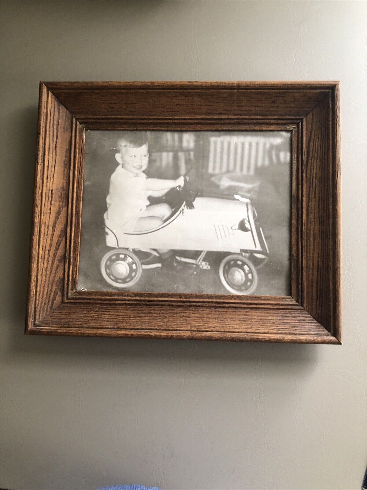 Old Black And White Photo Framed. Little Boy Driving Metal car 