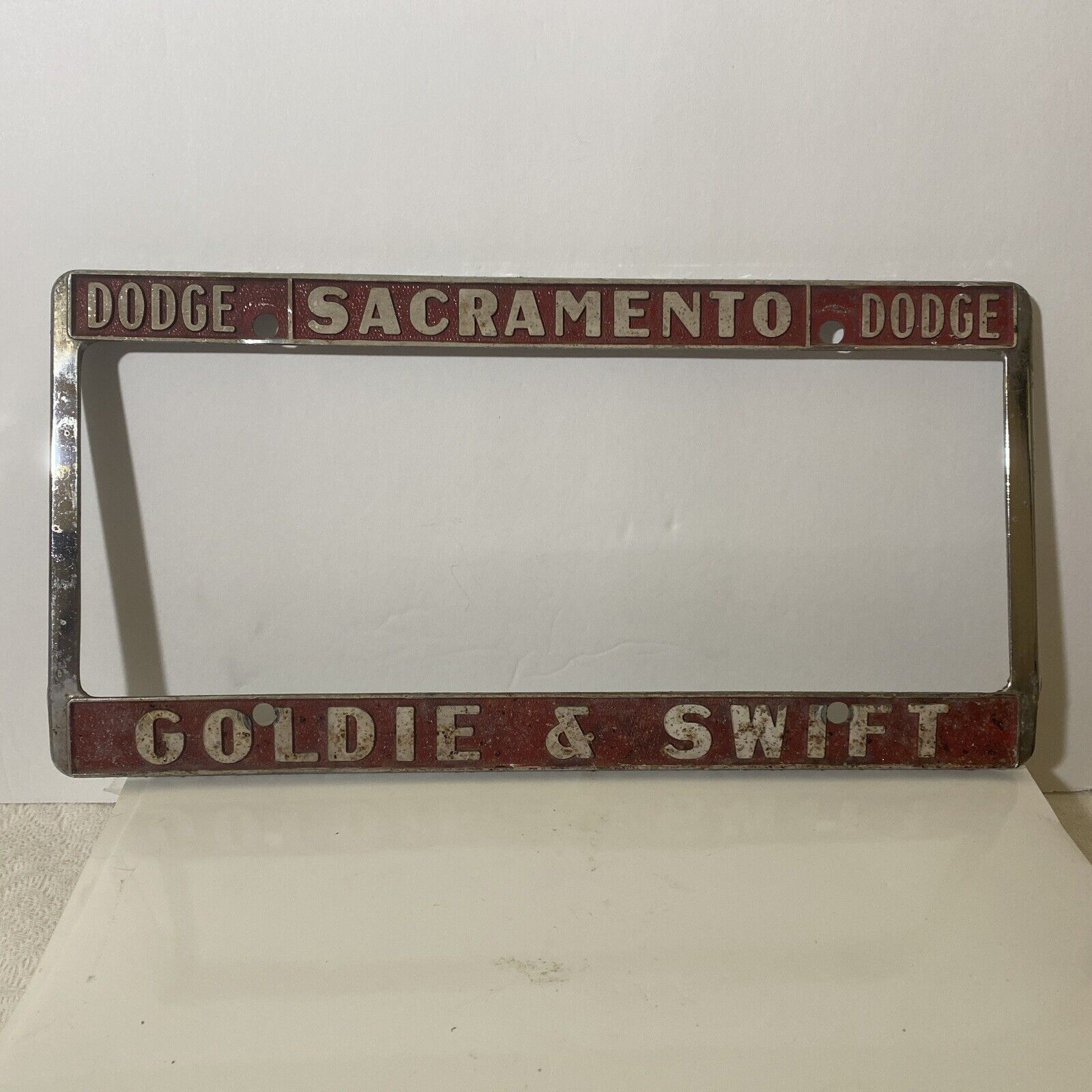 Vintage Sacramento Goldie &Swift Dodge Metal Embossed License Plate Frame