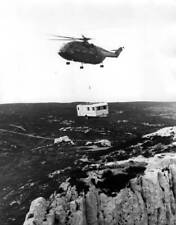 An Aerospatiale helicopter transports caravan holiday home over rock- Old Photo picture