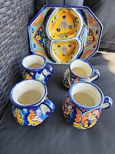Pottery from Mexico. One large divided dish and four matching mugs picture