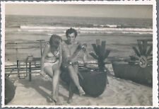1950s Beautiful girl in swimsuit and guy in trunks on the beach   Vintage Photo picture