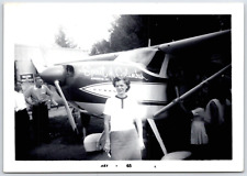 Photo Woman standing in front of Spirit of Columbus plane May 65 Cessna 180 picture