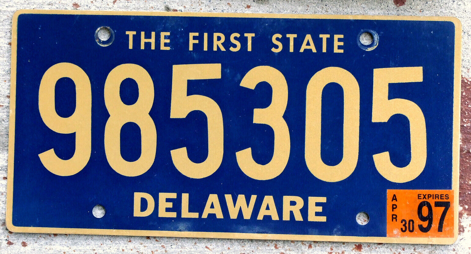Gold on Blue Delaware License Plate with a 1997 Sticker