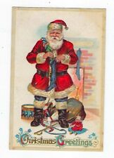 1911 Christmas Postcard Santa Stuffing Stockings Embossed Posted picture